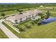 Aerial view of condo complex with pool, highlighting its waterfront setting at 17084 Acapulco Rd # 222, Punta Gorda, FL 33955