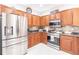 Updated kitchen with stainless steel appliances and wood cabinets at 17084 Acapulco Rd # 222, Punta Gorda, FL 33955