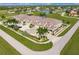 Aerial view showing a complex of condo buildings with parking and a lake at 17084 Acapulco Rd # 222, Punta Gorda, FL 33955
