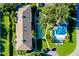 Aerial view of condo building, shuffleboard court, and pool area at 1515 Forrest Nelson Blvd # G102, Port Charlotte, FL 33952