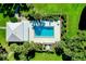Overhead view of community pool with surrounding landscaping and patio at 1515 Forrest Nelson Blvd # G102, Port Charlotte, FL 33952