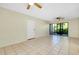 Living area with tile floors, sliding doors, and ceiling fan at 1515 Forrest Nelson Blvd # G102, Port Charlotte, FL 33952