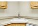 Corner kitchen sink with chrome faucet and wood cabinets at 1515 Forrest Nelson Blvd # G102, Port Charlotte, FL 33952