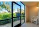 Private screened porch with chair, overlooking green space at 1515 Forrest Nelson Blvd # G102, Port Charlotte, FL 33952