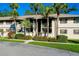 Two-story building exterior with landscaping and palm trees at 1515 Forrest Nelson Blvd # G102, Port Charlotte, FL 33952