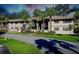 Two-story building with palm trees and landscaped grounds at 1515 Forrest Nelson Blvd # G102, Port Charlotte, FL 33952