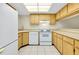 Bright kitchen featuring wood cabinets and white appliances at 1515 Forrest Nelson Blvd # G102, Port Charlotte, FL 33952