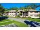 Two-story building with palm trees and landscaped grounds at 1515 Forrest Nelson Blvd # G102, Port Charlotte, FL 33952