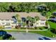 Two-story building exterior with landscaping and palm trees at 1515 Forrest Nelson Blvd # G102, Port Charlotte, FL 33952