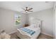 Guest bedroom with ceiling fan and window with shutters at 15466 Seafoam Cir, Port Charlotte, FL 33981