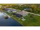 Aerial view of the house, pool, and canal-front location at 15466 Seafoam Cir, Port Charlotte, FL 33981