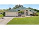 Single-story home with green roof and landscaping at 7339 Powder Puff, Punta Gorda, FL 33955