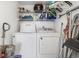 Functional laundry room with washer, dryer, and ample storage shelves at 175 Kings Hwy # B6-526, Punta Gorda, FL 33983