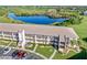 Aerial view of condo building near water, with parking and lush landscaping at 175 Kings Hwy # B6-526, Punta Gorda, FL 33983