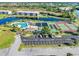 Aerial view of community with pool, tennis courts, and residential buildings at 175 Kings Hwy # B6-526, Punta Gorda, FL 33983