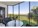 Relaxing screened patio with table and chairs overlooking a tranquil view at 175 Kings Hwy # B6-526, Punta Gorda, FL 33983