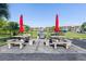 Community grilling area with picnic tables and red umbrellas at 175 Kings Hwy # B6-526, Punta Gorda, FL 33983