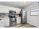 Bright kitchen with stainless steel appliances and light wood laminate floors at 175 Kings Hwy # B6-526, Punta Gorda, FL 33983