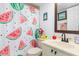 Charming bathroom with watermelon shower curtain and updated vanity at 175 Kings Hwy # B6-526, Punta Gorda, FL 33983