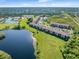 Complex overview: multiple condo buildings, parking, and a beautiful lake at 175 Kings Hwy # B6-526, Punta Gorda, FL 33983