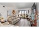 Spacious living room with light beige reclining sofas and water views at 175 Kings Hwy # B6-526, Punta Gorda, FL 33983
