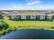 Condo building overlooking a serene lake, offering picturesque water views at 175 Kings Hwy # B6-526, Punta Gorda, FL 33983
