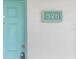 Light teal front door with a white wall and address plaque at 175 Kings Hwy # B6-526, Punta Gorda, FL 33983