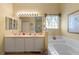 Bathroom with double vanity and bathtub at 1676 Palace Ct, Punta Gorda, FL 33980