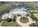 Aerial view of community pool, clubhouse, and golf course at 1676 Palace Ct, Punta Gorda, FL 33980