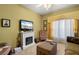 Relaxing living room with fireplace, comfortable seating, and large window at 1676 Palace Ct, Punta Gorda, FL 33980