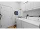 Bright laundry room with washer, dryer, and cabinets at 1676 Palace Ct, Punta Gorda, FL 33980