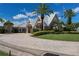 Elegant clubhouse entrance with palm trees and landscaping at 1676 Palace Ct, Punta Gorda, FL 33980