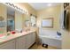 Bathroom with double vanity, bathtub and shower at 1676 Palace Ct, Punta Gorda, FL 33980