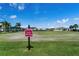 Lawn bowling green with signage and a picturesque background at 1676 Palace Ct, Punta Gorda, FL 33980