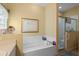 Bathroom with bathtub and shower, plus built-in shelving at 1676 Palace Ct, Punta Gorda, FL 33980