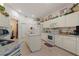 Bright kitchen with island, granite countertops, and white cabinets at 1676 Palace Ct, Punta Gorda, FL 33980