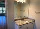 Well lit bathroom with a single sink vanity, granite countertop, and a large, well lit mirror at 14326 Edsel Dr, Port Charlotte, FL 33981