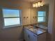 Bathroom featuring a vanity with granite countertop, mirror, and natural light from window at 14326 Edsel Dr, Port Charlotte, FL 33981