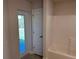 Bathroom with a shower and bathtub combination and a glass door leading to an outdoor lawn at 14326 Edsel Dr, Port Charlotte, FL 33981