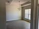 Dining room with wood-look tile flooring, chandelier, and natural light from window at 14326 Edsel Dr, Port Charlotte, FL 33981