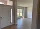 Welcoming foyer featuring tile floors and a view into the living area with a window at 14326 Edsel Dr, Port Charlotte, FL 33981