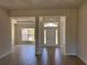 Spacious living area with tile flooring, columns, and a view of the entry and dining area at 14326 Edsel Dr, Port Charlotte, FL 33981