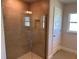 Shower featuring light brown tile walls with a glass door, and a shower caddy for toiletries at 14326 Edsel Dr, Port Charlotte, FL 33981