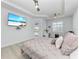 A bedroom with a ceiling fan, a flat screen TV and a view of the screened porch at 630 Coronado Dr, Punta Gorda, FL 33950