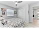 Bedroom featuring a ceiling fan, light wood floors, a closet, and access to bath at 630 Coronado Dr, Punta Gorda, FL 33950