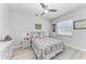 Bedroom featuring a ceiling fan, light wood floors, and dresser at 630 Coronado Dr, Punta Gorda, FL 33950