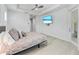 Bedroom featuring a ceiling fan, light wood floors, and access to the bath at 630 Coronado Dr, Punta Gorda, FL 33950