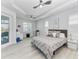 A bedroom with an elegant ceiling fan, a platform bed, and light-colored hardwood floors at 630 Coronado Dr, Punta Gorda, FL 33950