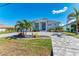 Attractive single-story home with a well-manicured lawn, palm trees, and a paver driveway at 630 Coronado Dr, Punta Gorda, FL 33950
