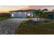 Beautiful single-Gathering home with a brick driveway, tropical landscaping, and a two-car garage at 630 Coronado Dr, Punta Gorda, FL 33950